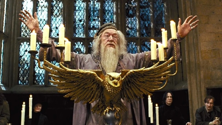 Dumbledore stands behind a lectern