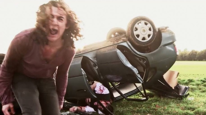 Drew Casson screams near a wrecked car