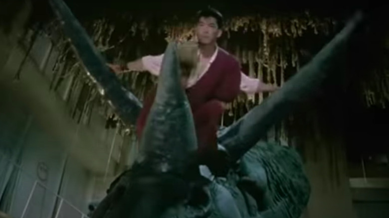 Yuen Biao rides dinosaur