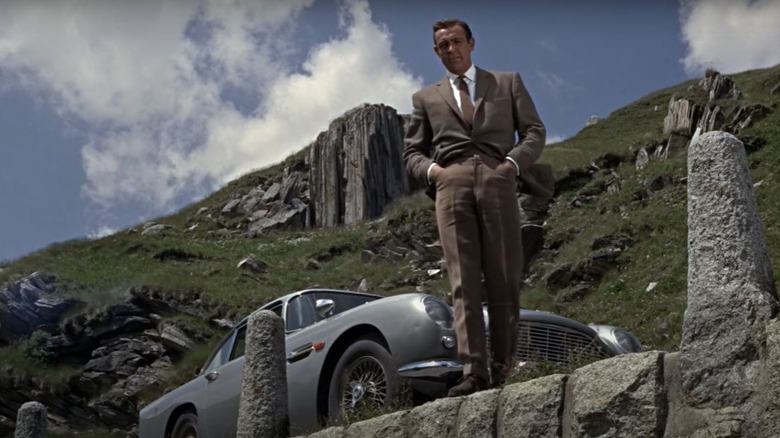 James Bond standing by car