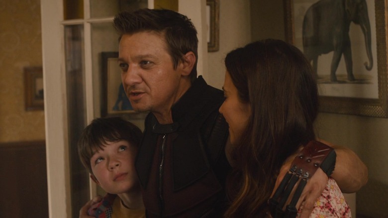 Hawkeye hugging his wife and son