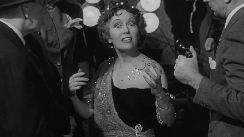 Norma Desmond surrounded by reporters