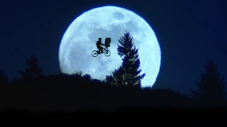 Eliott and ET silhouette on moon