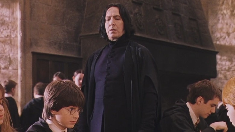 Snape stands over Harry Potter