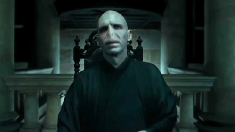 The Dark Lord presides at the head of a Death Eaters council.