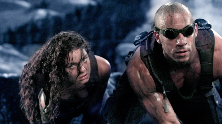 Riddick and Kyra hide from aliens in "Chronicles of Riddick" (2004)