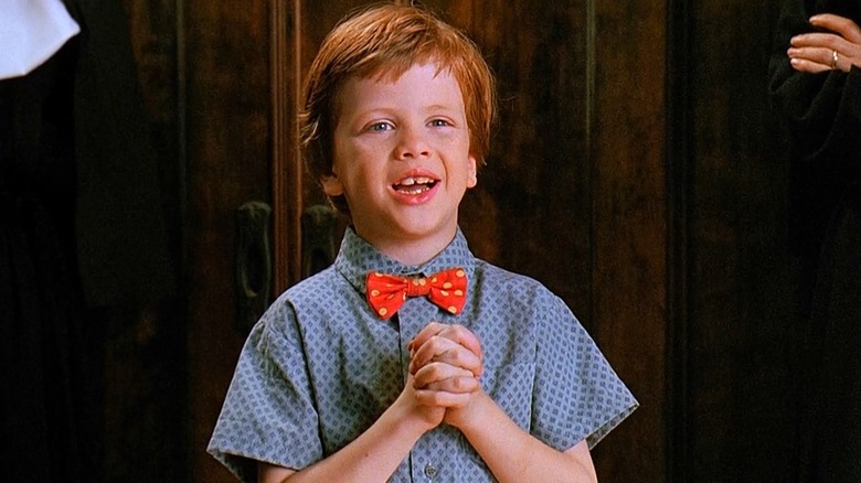 Junior Healy holds his hands in prayer in "Problem Child" (1990)