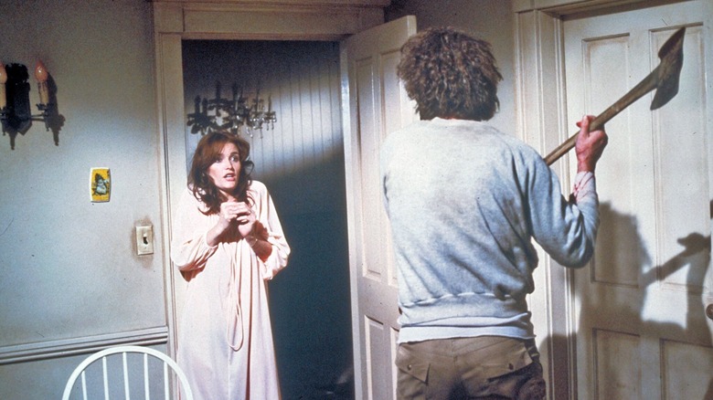 George Lutz wields an ax at his wife in "The Amityville Horror" (1979)