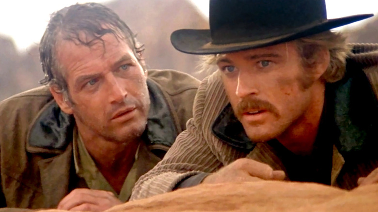 Butch Cassidy and the Sundance Kid hiding behind rocks