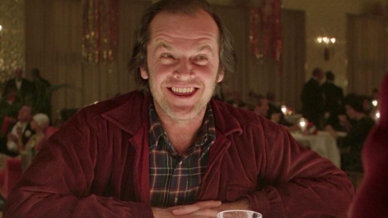 Jack Torrance smiling with drink