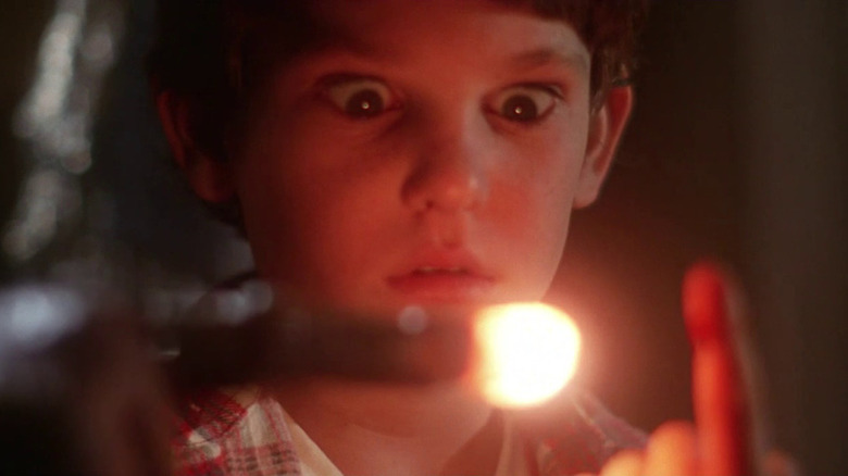 Elliot looking at E.T..'s glowing finger