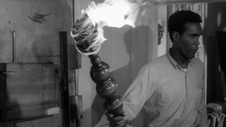 Duane Jones with a lit torch