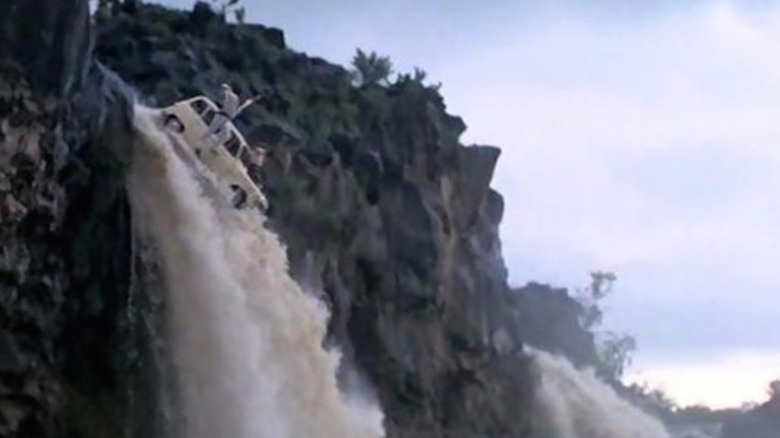 A jeep heads over a waterfall