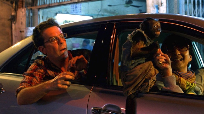 Stu and monkey lean out car windows