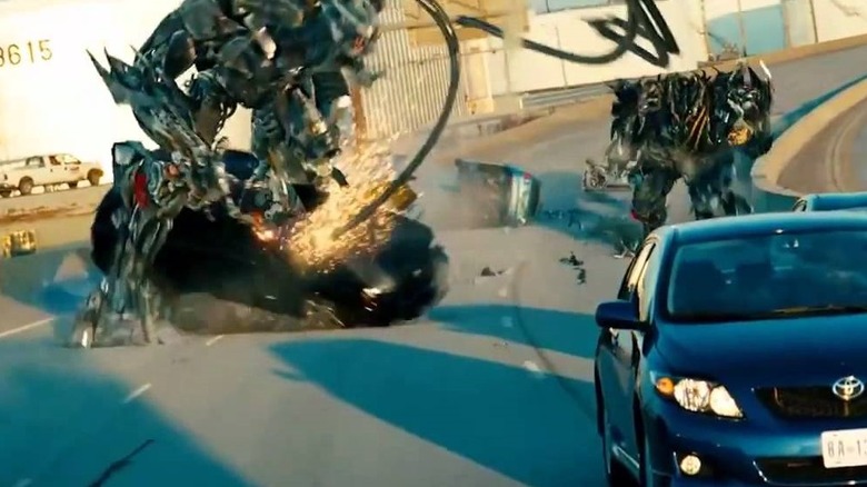 Transformers wrecking cars on highway