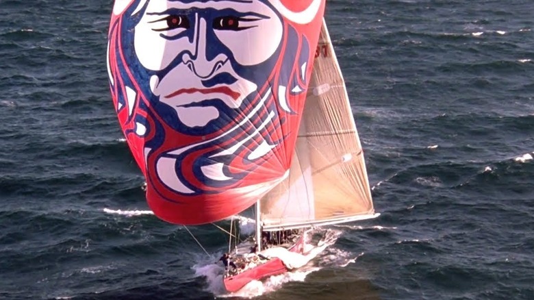 A sailboat moves on the ocean