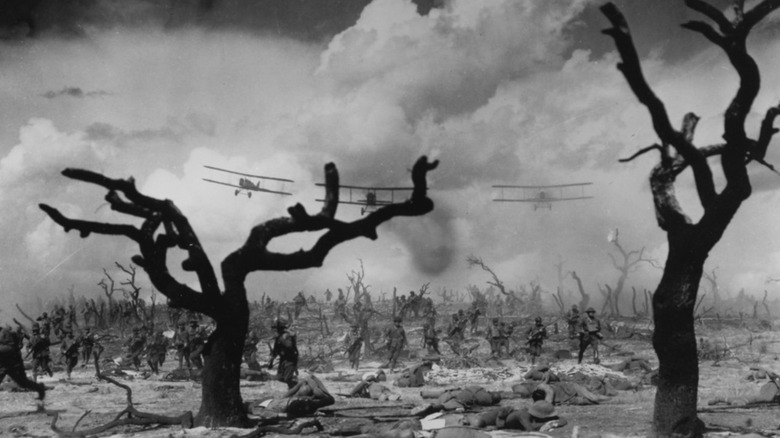 Planes fly over a battlefield