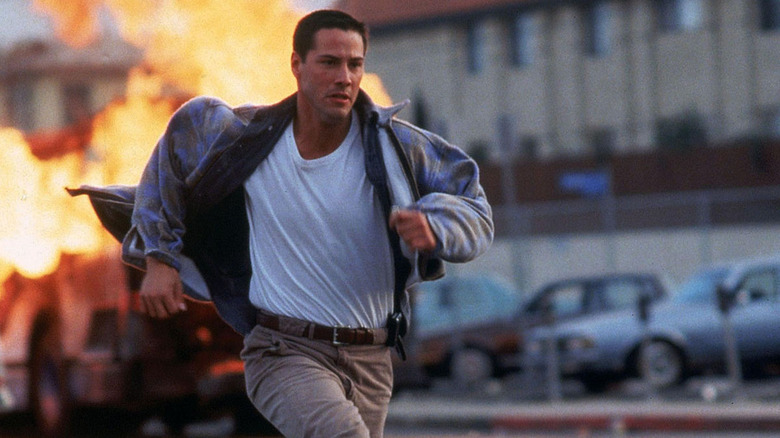 Keanu Reeves running from danger