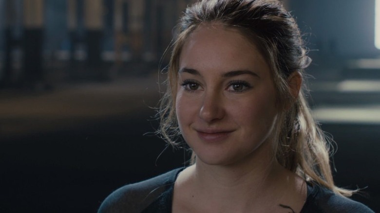 Tris smiling in a room