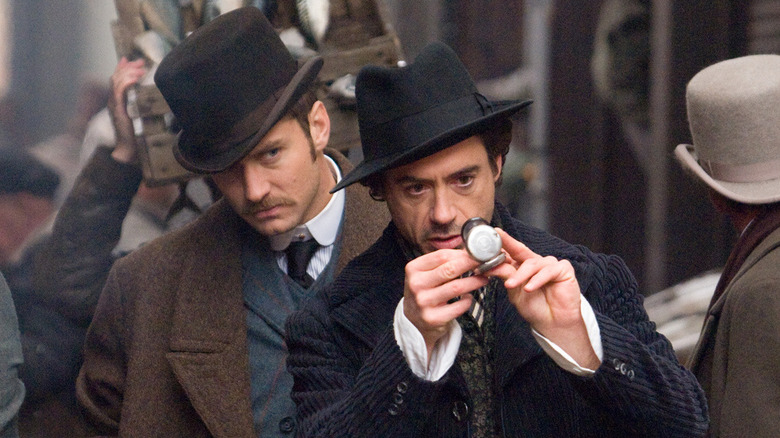 Holmes and Watson look at stopwatch