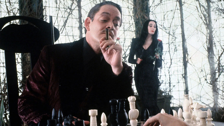 Gomez Addams plays chess with Thing