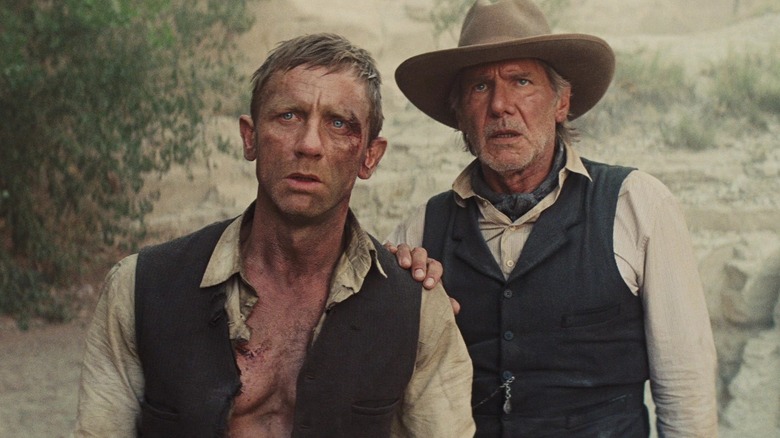 Daniel Craig and Harrison Ford staring in desert