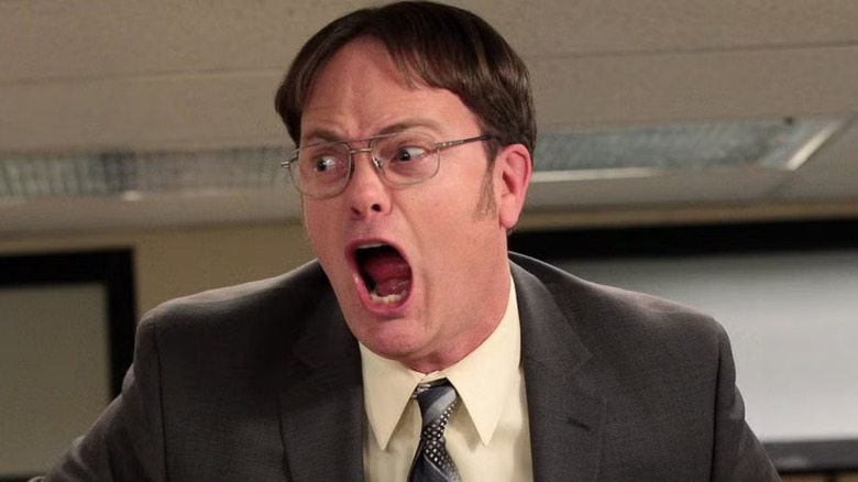 Dwight Schrute screams atop a desk in 