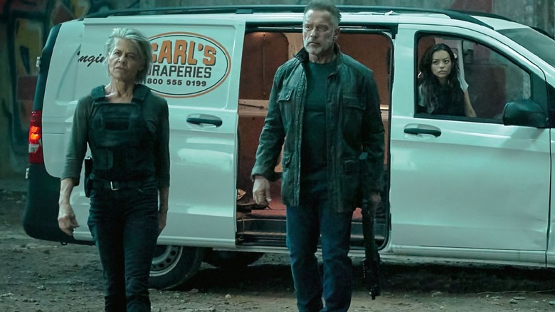 Sarah Connor and the Terminator get out of a van in "Terminator: Dark Fate" (2019)