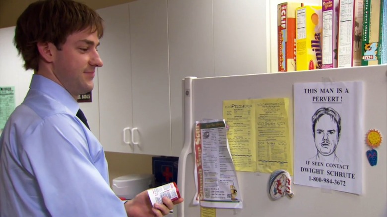 Jim smirks at Dwight's "wanted" poster on the fridge in "The Office" (2007)