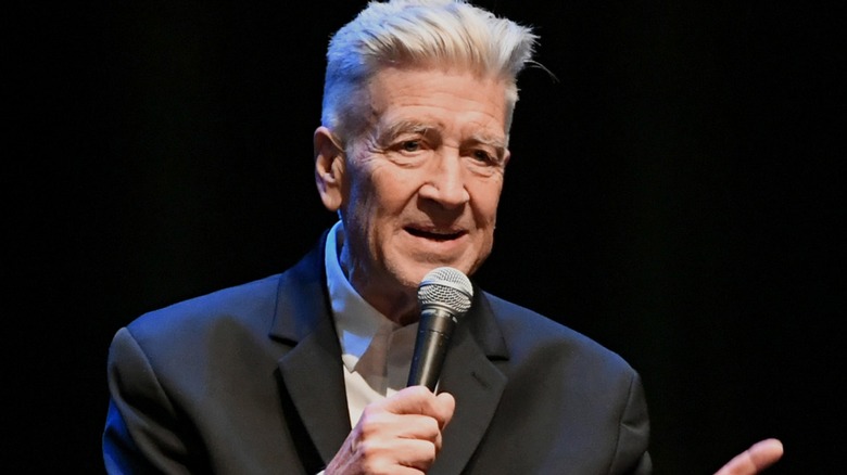 David Lynch speaking into microphone