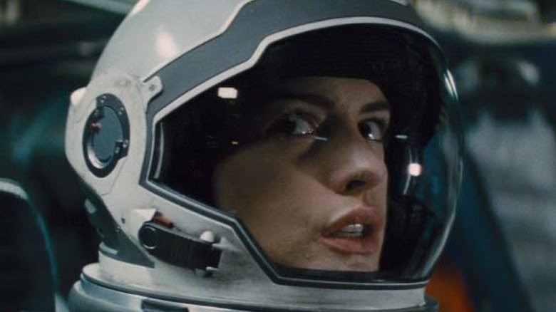 Anne Hathaway peers through helmet