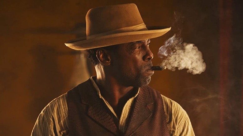 Michael K. Williams smokes a cigar