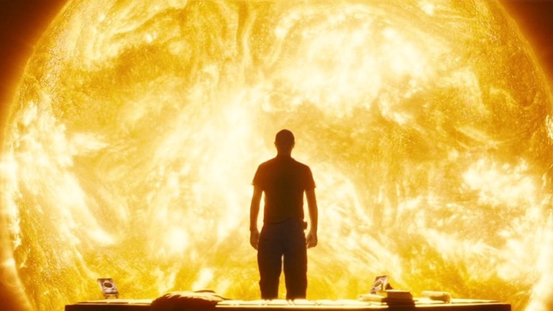 Man stands in front of sun
