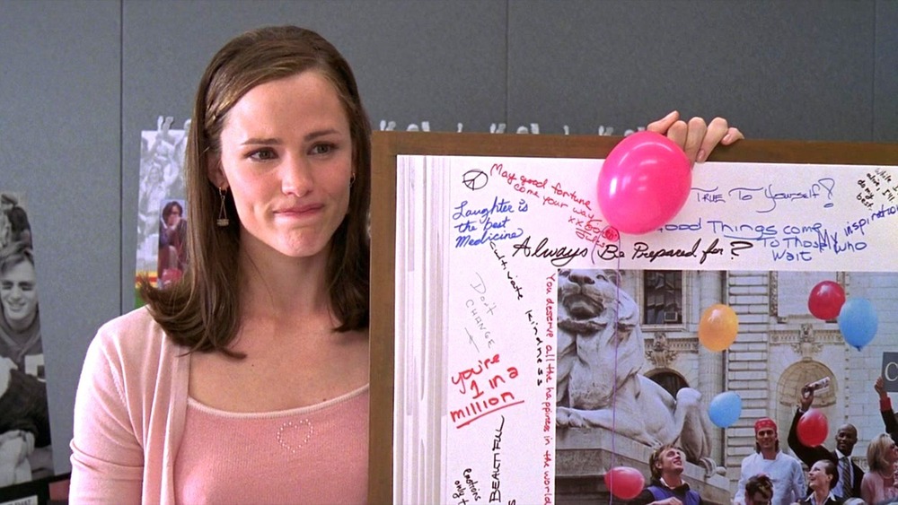 Jennifer Garner holds a poster in 13 Going on 30