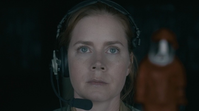 Amy Adams wears a headset 