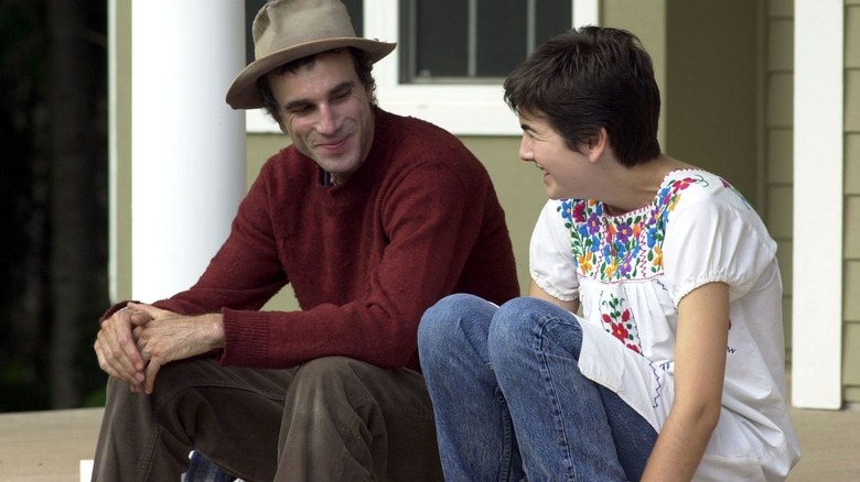 Daniel Day-Lewis happily listening to a story