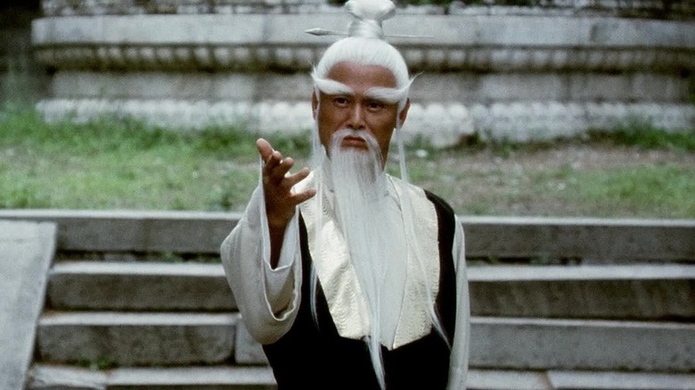 Pai Mei holding out hand