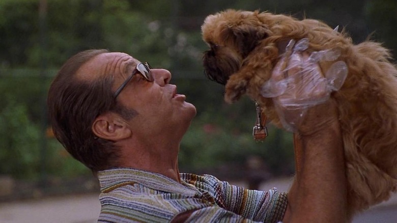 Jack Nicholson holding up dog