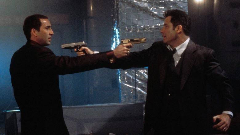 Cage and Travolta with guns