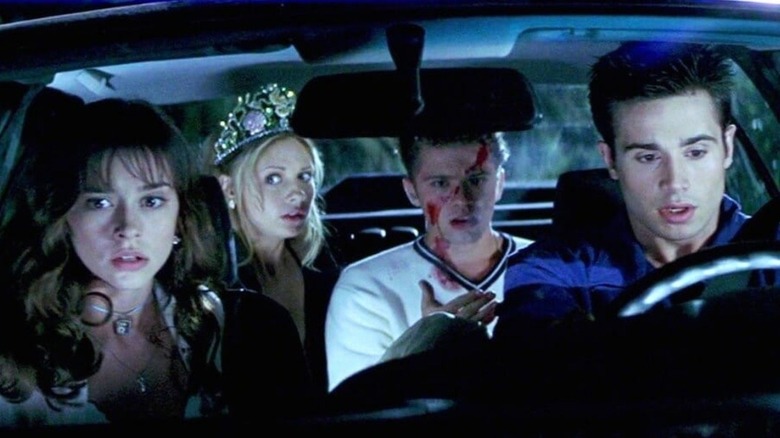 Shocked, bloody teens in a car