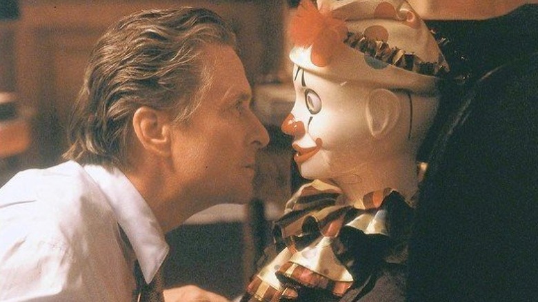 Michael Douglas examining toy clown