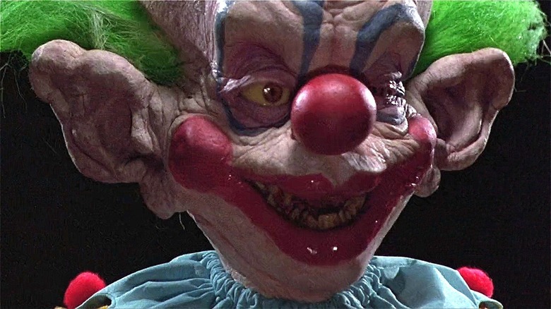 A killer clown looks right