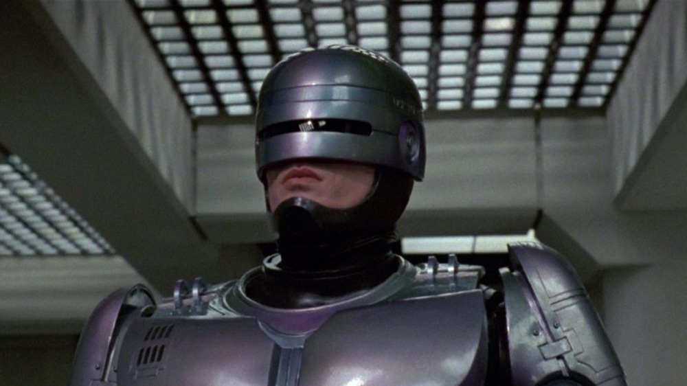 RoboCop walking down hallway