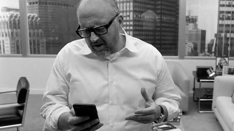 Louis C.K. looking at his phone