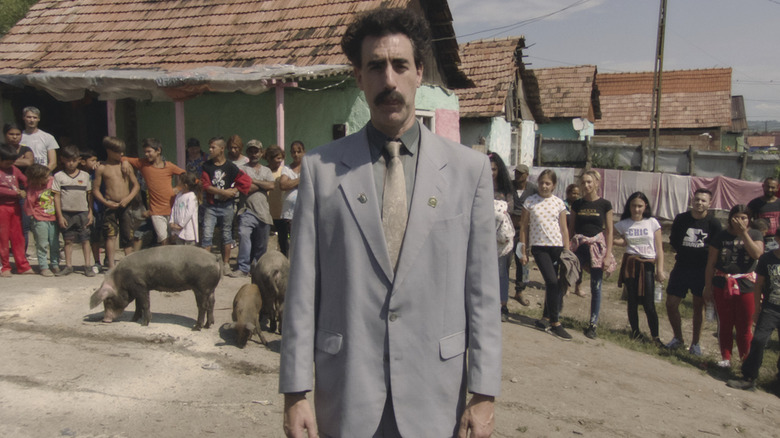 Borat stands near a line of people