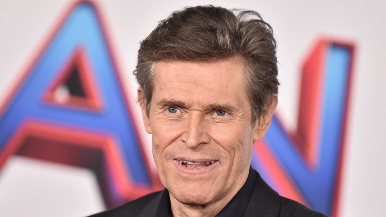 Willem Dafoe smiles