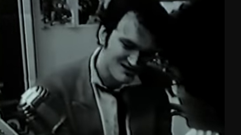 Tarantino near a mic in "My Best Friend's Birthday" (1987)