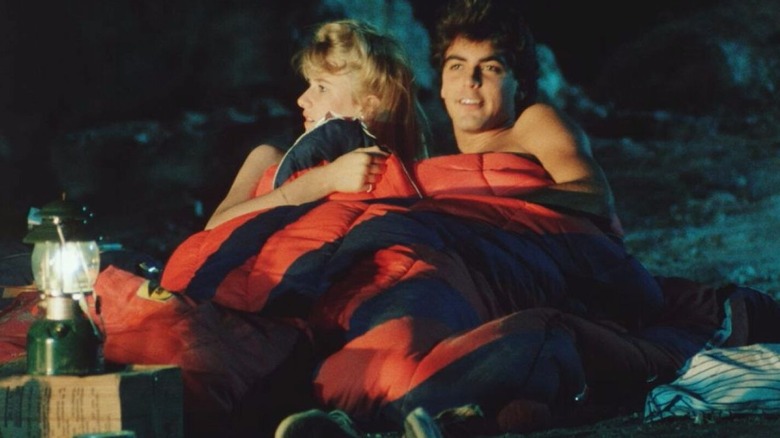 Ron and Tina outdoors in a sleeping bag