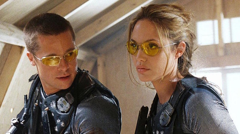 Brad Pitt looks at Angelina Jolie in bulletproof vest