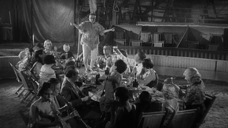 Circus performers gather at a table